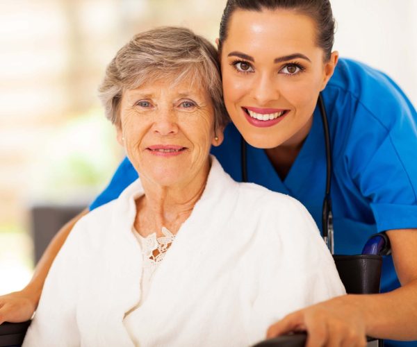 4- Young nurse and elderly patient posing together for a photo.